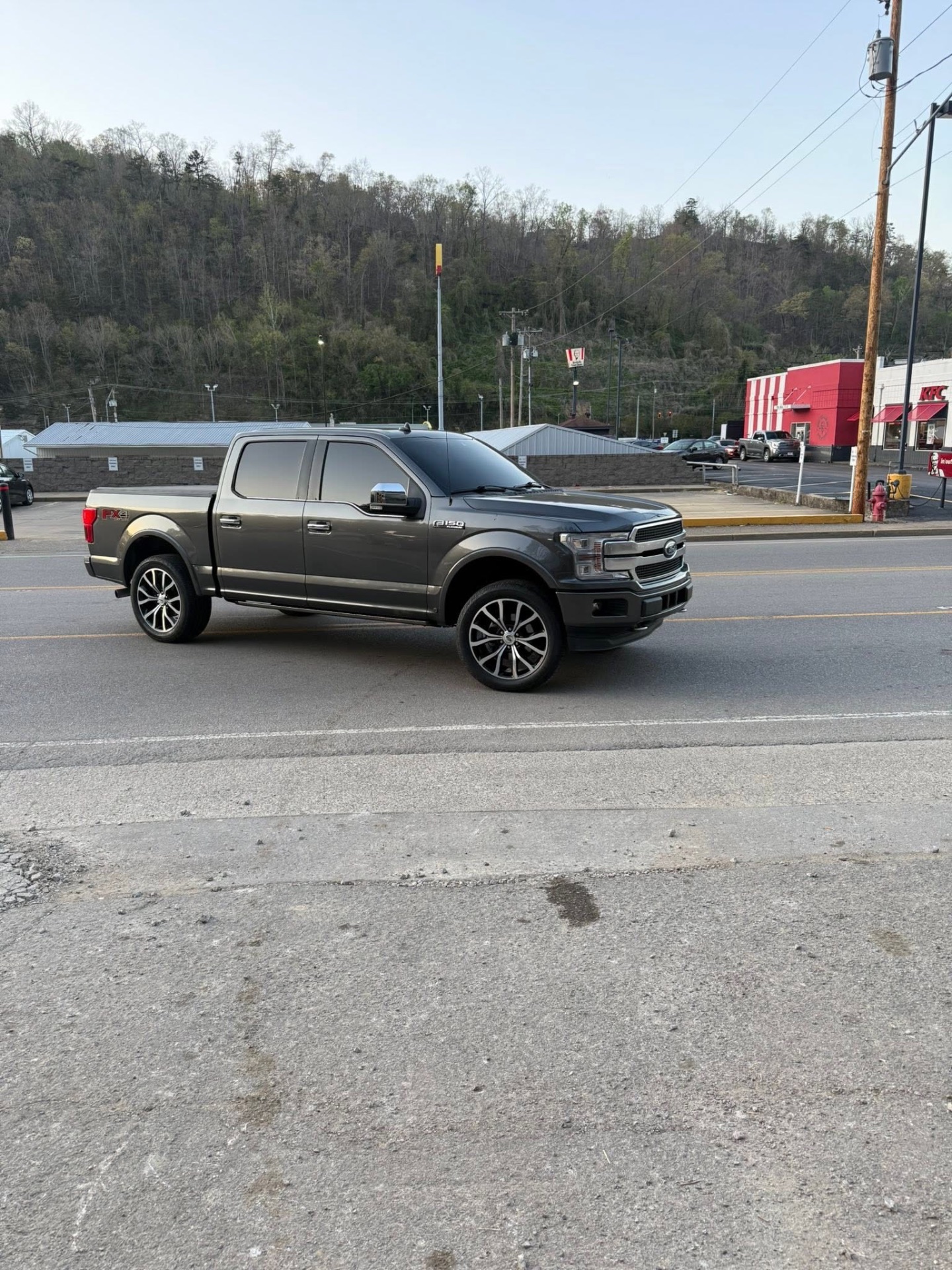 Ford F-150 FX4 with custom rims on Pikeville street
