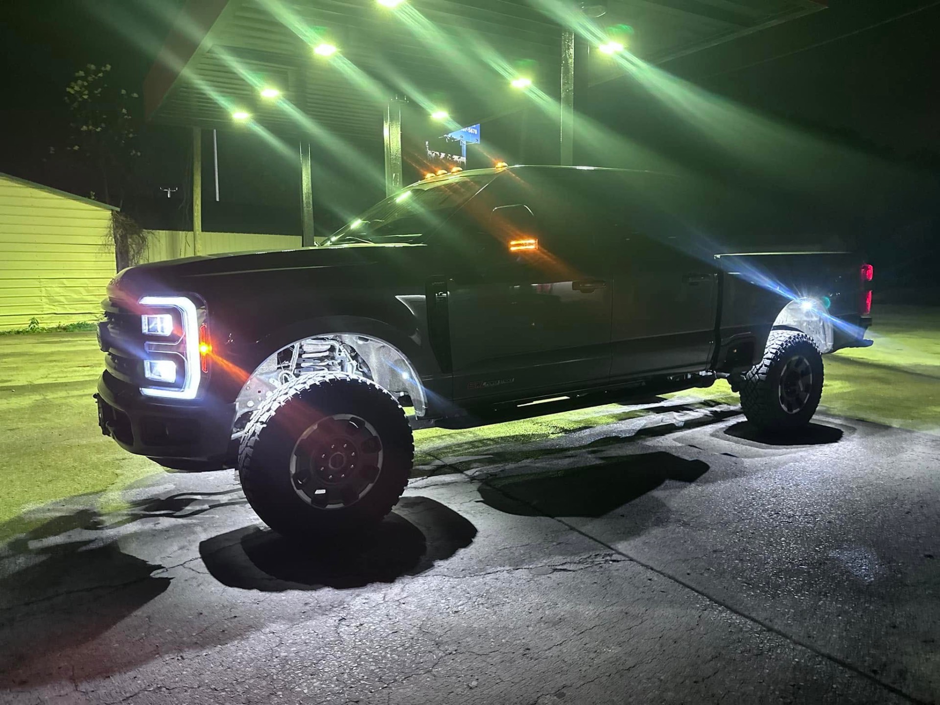 Lifted Ford F-250 at night with full LED lighting